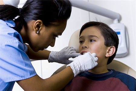 dentist child - Boy having dental exam Stock Photo - Premium Royalty-Free, Code: 640-02771549