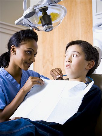 dentist child - Boy at dentist with hygienist Stock Photo - Premium Royalty-Free, Code: 640-02771557