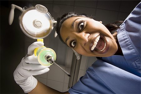 Dental hygienist with syringe dramatic angle Stock Photo - Premium Royalty-Free, Code: 640-02771704