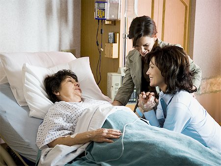 Two women talking with mature woman in hospital Stock Photo - Premium Royalty-Free, Code: 640-02771787
