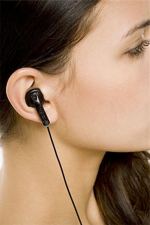 simsearch:640-02775245,k - Closeup of female ear with earbud Stock Photo - Premium Royalty-Free, Code: 640-02772190