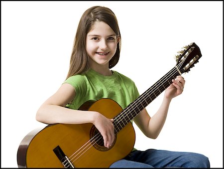 simsearch:640-02772211,k - Girl with braces playing guitar smiling Foto de stock - Sin royalties Premium, Código: 640-02772210