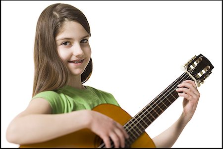 simsearch:640-02772211,k - Girl with braces playing guitar smiling Foto de stock - Sin royalties Premium, Código: 640-02772212