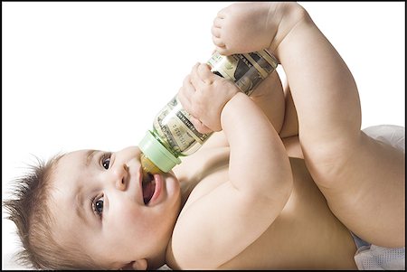 simsearch:640-01352199,k - Baby drinking from bottle with US currency in it Fotografie stock - Premium Royalty-Free, Codice: 640-02772326