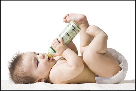 Baby drinking from bottle with US currency in it Stock Photo - Premium Royalty-Free, Code: 640-02772327