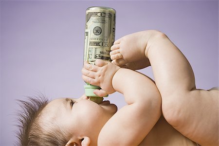 simsearch:640-01352199,k - Baby drinking from bottle with US currency in it Fotografie stock - Premium Royalty-Free, Codice: 640-02772323