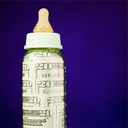 Baby bottle with US currency in it Stock Photo - Premium Royalty-Free, Code: 640-02772355