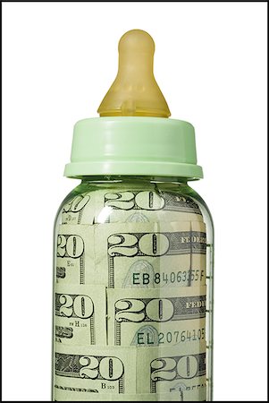 Baby bottle with US currency in it Stock Photo - Premium Royalty-Free, Code: 640-02772353