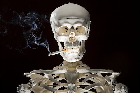 skull bones - Closeup of skeleton smoking cigarette Stock Photo - Premium Royalty-Free, Code: 640-02772383