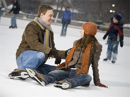 Couple falling while ice skating Stock Photo - Premium Royalty-Free, Code: 640-02772464