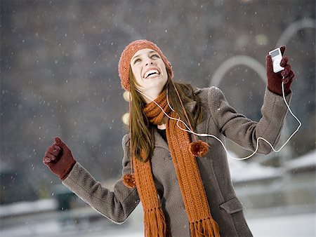 simsearch:640-02775245,k - Woman with mp3 player outdoors in winter smiling Stock Photo - Premium Royalty-Free, Code: 640-02772468