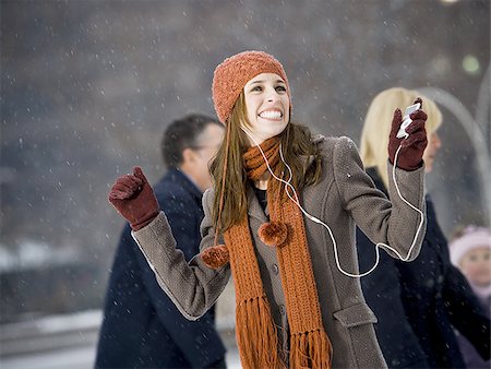 simsearch:640-01353835,k - Woman with mp3 player outdoors in winter smiling Stock Photo - Premium Royalty-Free, Code: 640-02772469