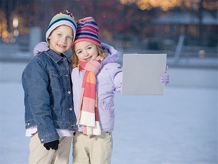 simsearch:640-02772458,k - Two girls outdoors in winter with blank sign Stock Photo - Premium Royalty-Free, Code: 640-02772474