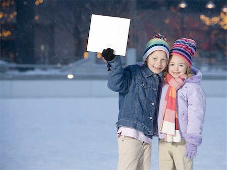 simsearch:640-02772715,k - Two girls outdoors in winter with blank sign Stock Photo - Premium Royalty-Free, Code: 640-02772475