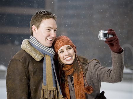 simsearch:640-02772458,k - Man and woman taking a photo outdoors in winter Stock Photo - Premium Royalty-Free, Code: 640-02772471