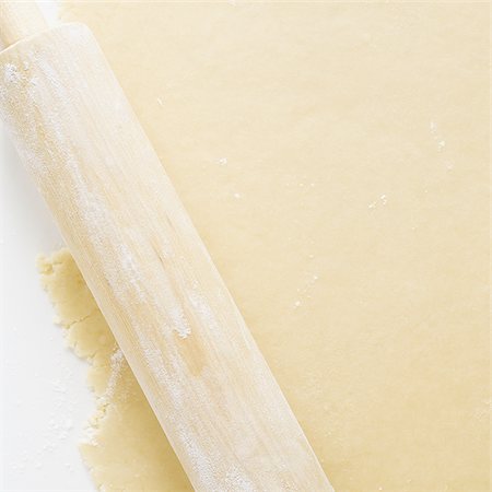 rolling dough - Detailed view of dough with rolling pin Stock Photo - Premium Royalty-Free, Code: 640-02772551