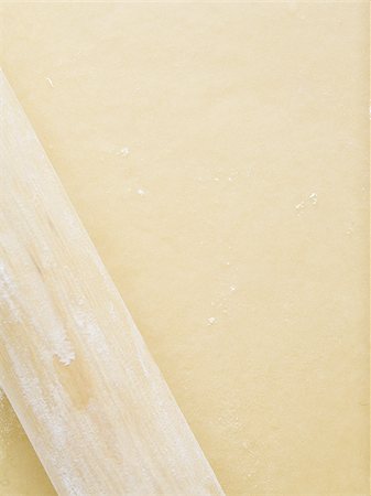simsearch:640-02772561,k - Detailed view of dough with rolling pin Stock Photo - Premium Royalty-Free, Code: 640-02772552