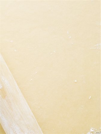 simsearch:640-02772561,k - Detailed view of dough with rolling pin Stock Photo - Premium Royalty-Free, Code: 640-02772553