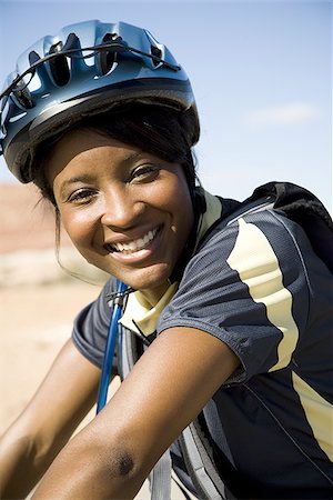 simsearch:640-01353835,k - Female cyclist with helmet outdoors smiling Stock Photo - Premium Royalty-Free, Code: 640-02773182