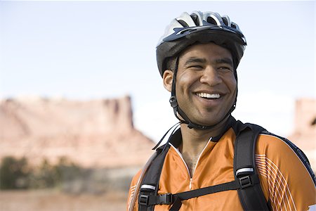 Male cyclist with helmet outdoors smiling Stock Photo - Premium Royalty-Free, Code: 640-02773202