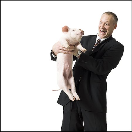 pig silhouette - Businessman holding piglet Stock Photo - Premium Royalty-Free, Code: 640-02773253