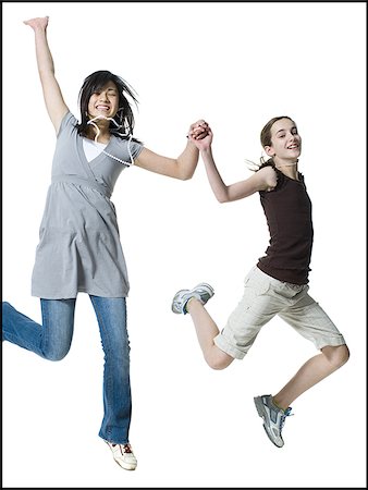 simsearch:640-02773517,k - Two girls jumping and smiling Stock Photo - Premium Royalty-Free, Code: 640-02773290