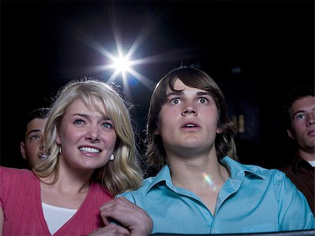 simsearch:640-02773489,k - Boy and girl with popcorn frightened at movie theater Fotografie stock - Premium Royalty-Free, Codice: 640-02773378