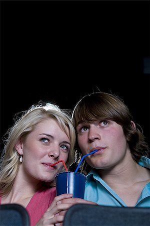 Boy and girl sharing beverage at movie theater Stock Photo - Premium Royalty-Free, Code: 640-02773400