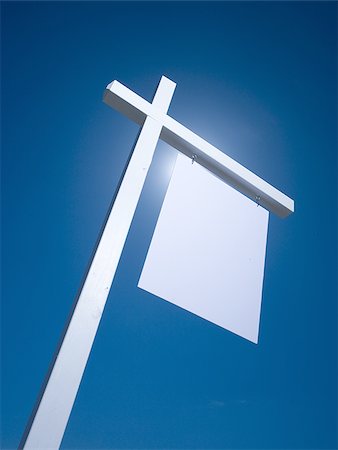 simsearch:640-02773714,k - Blank sign hanging outdoors with blue sky Fotografie stock - Premium Royalty-Free, Codice: 640-02773425