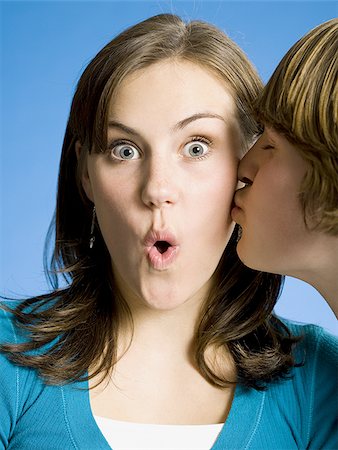 simsearch:640-02773489,k - Closeup of boy kissing girl on cheek Fotografie stock - Premium Royalty-Free, Codice: 640-02773493