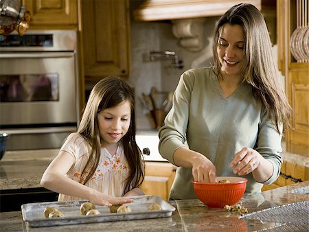 simsearch:640-01357998,k - Girl in kitchen with woman baking cookies Stock Photo - Premium Royalty-Free, Code: 640-02773559