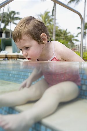 Girl sitting in outdoor pool Stock Photo - Premium Royalty-Free, Code: 640-02773704