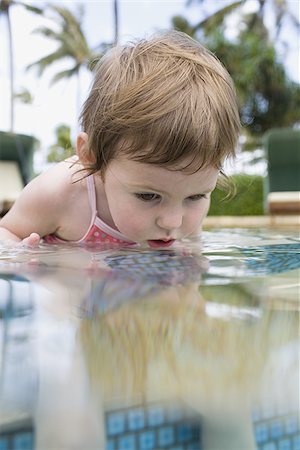 Girl sitting in outdoor pool Stock Photo - Premium Royalty-Free, Code: 640-02773703