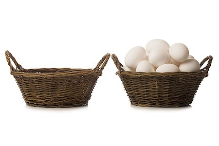 One empty basket and one filled with eggs Stock Photo - Premium Royalty-Free, Code: 640-02773723