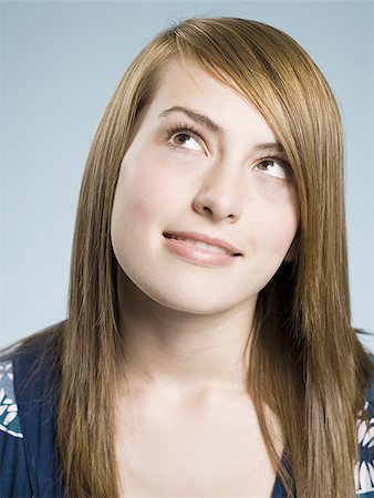 Girl looking up biting lip Stock Photo - Premium Royalty-Free, Code: 640-02773788