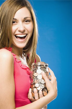simsearch:640-02773597,k - Woman holding jar filled with coins smiling Foto de stock - Sin royalties Premium, Código: 640-02773942