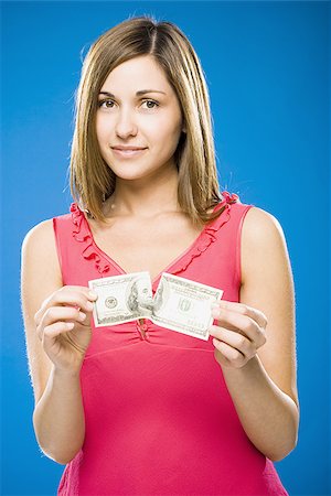 simsearch:640-01458889,k - Femme déchirant le billet de cent dollars américains Photographie de stock - Premium Libres de Droits, Code: 640-02773974