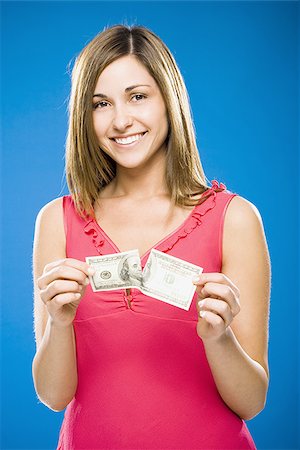 simsearch:640-01458889,k - Femme déchirant le billet de cent dollars américains Photographie de stock - Premium Libres de Droits, Code: 640-02773975