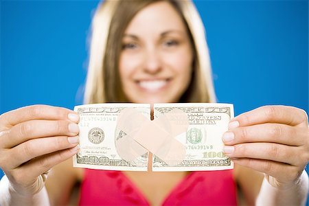 Woman with torn one hundred dollar American banknote with plastic strip Foto de stock - Sin royalties Premium, Código: 640-02773990
