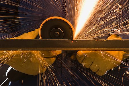 man in blue coveralls with a power grinder Foto de stock - Sin royalties Premium, Código: 640-02947745