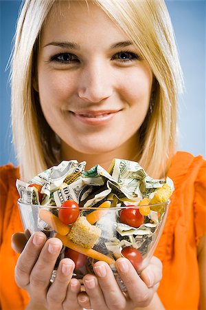 woman eating a salad made of money Stock Photo - Premium Royalty-Free, Code: 640-02947865