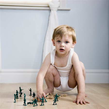 little boy playing with toy soldiers Stock Photo - Premium Royalty-Free, Code: 640-02947950