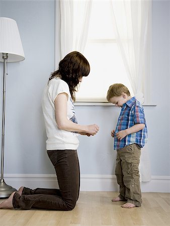 boy putting on clothes