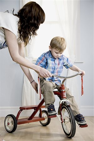 little boy riding a tricycle Stock Photo - Premium Royalty-Free, Code: 640-02947981