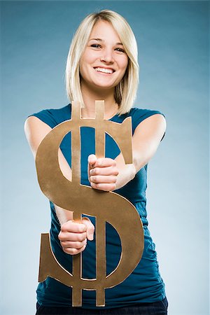 woman holding up a dollar symbol Stock Photo - Premium Royalty-Free, Code: 640-02948195