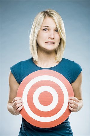 scared young woman one not man not asian - woman holding up a target Stock Photo - Premium Royalty-Free, Code: 640-02948190