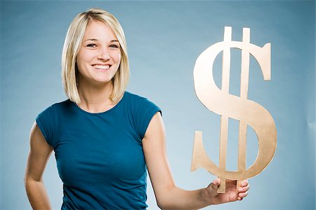 woman holding up a dollar symbol Stock Photo - Premium Royalty-Free, Code: 640-02948200