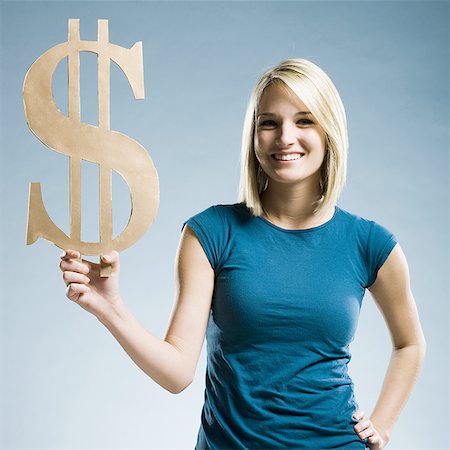 dollar sign - woman holding up a dollar symbol Stock Photo - Premium Royalty-Free, Code: 640-02948202