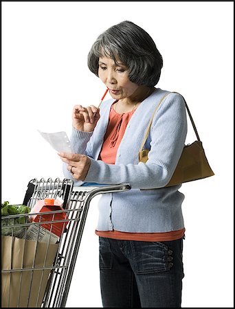 woman looking at a shopping list Stock Photo - Premium Royalty-Free, Code: 640-02948407