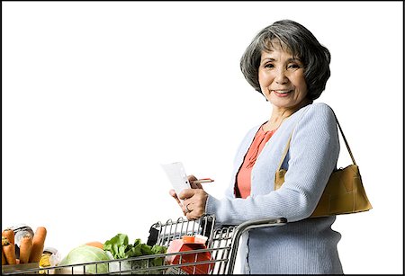 shopping japanese - woman looking at a shopping list Stock Photo - Premium Royalty-Free, Code: 640-02948411
